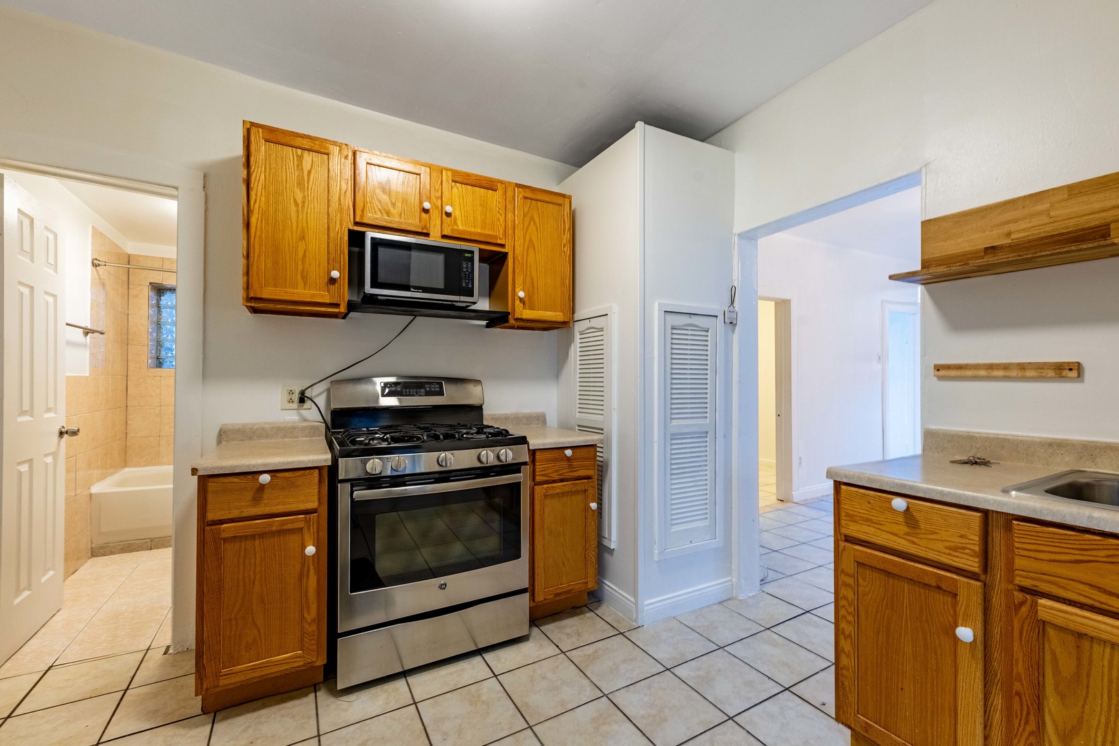 2109 West Cullerton Street Chicago, IL 60608 - Photo 11 of 14 a kitchen with stainless steel appliances granite countertop a stove a microwave and a refrigerator