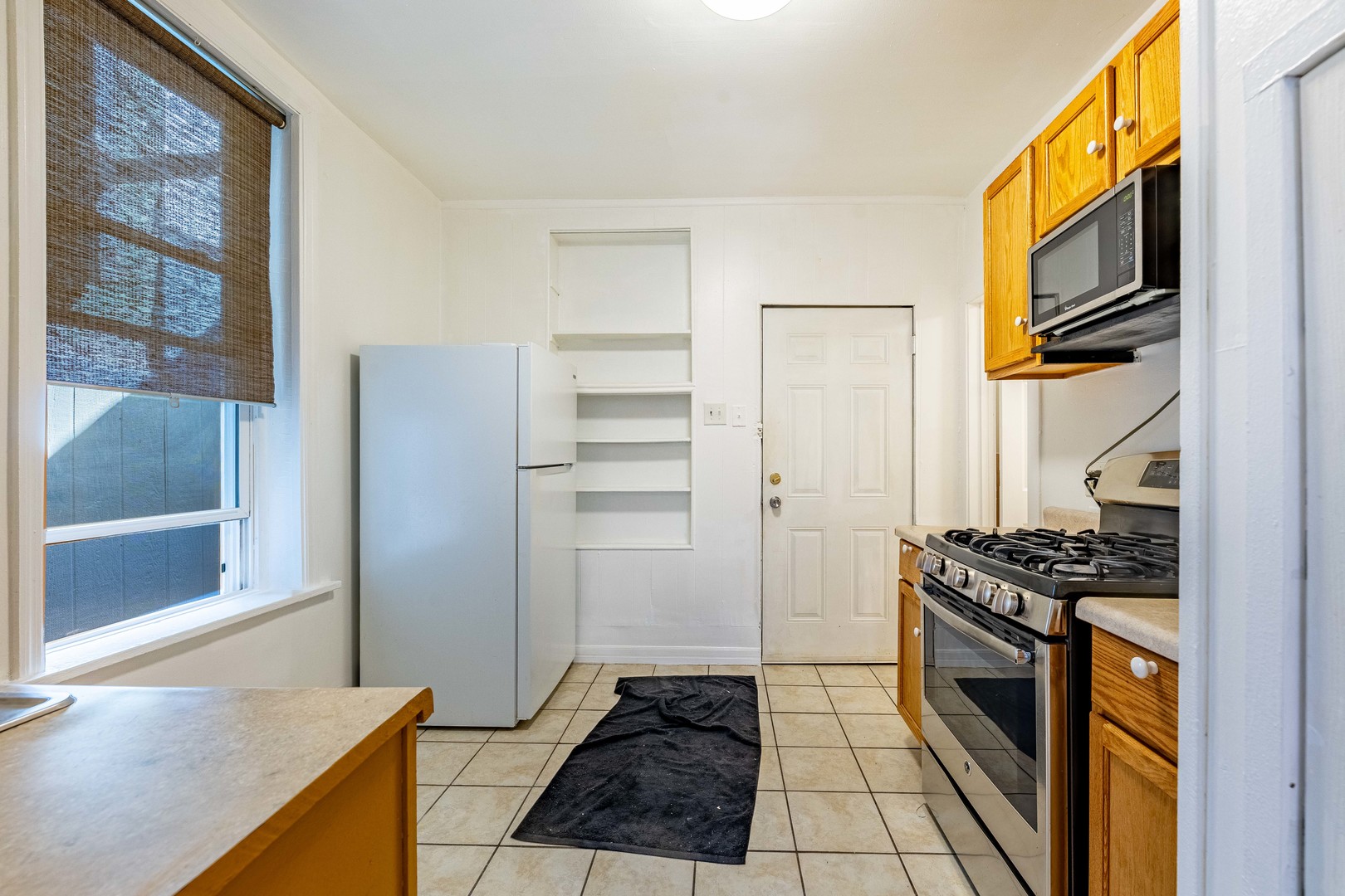 2109 West Cullerton Street Chicago, IL 60608 - Photo 12 of 14 a kitchen with granite countertop a refrigerator and a stove