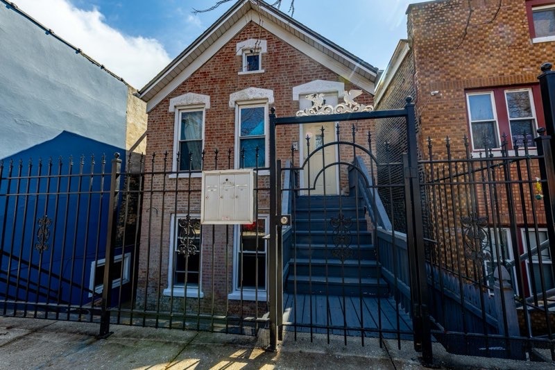 2109 West Cullerton Street Chicago, IL 60608 - Photo 2 of 14 a front view of a house with wooden stairs