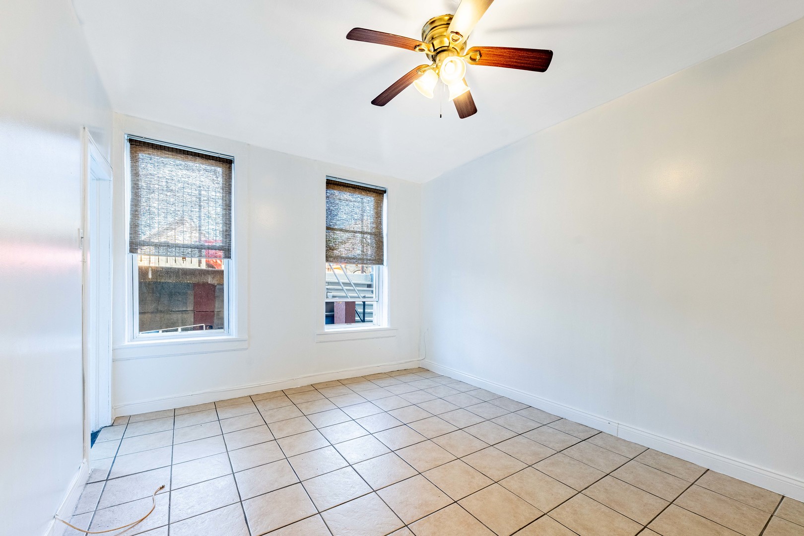 2109 West Cullerton Street Chicago, IL 60608 - Photo 5 of 14 an empty room with chandelier fan and windows