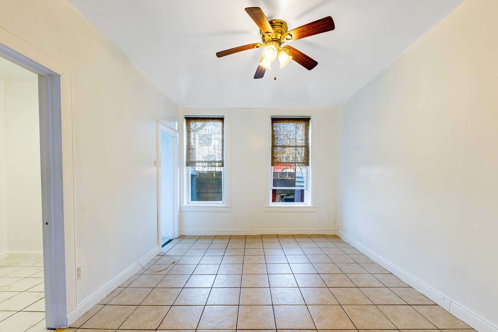 2109 West Cullerton Street Chicago, IL 60608 - Photo 9 of 14 an empty room with chandelier fan and windows