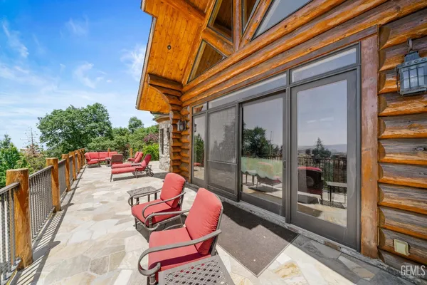a balcony with table and chairs