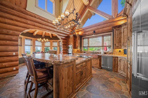 a living room with furniture a fireplace and a large window