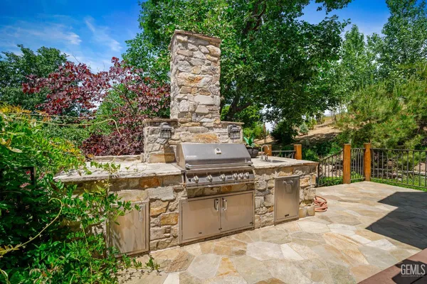 a view of a patio with table and chairs and potted plants
