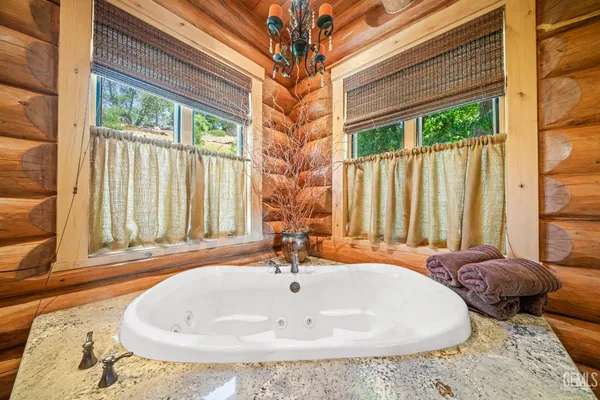 a bathroom with a granite countertop shower a sink and a mirror