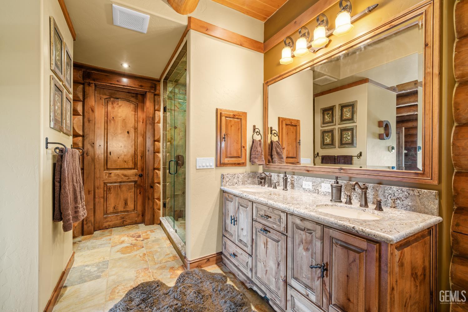 Undisclosed Address Tehachapi, CA 93561 - Photo 31 of 73 a bathroom with a double vanity sink and a mirror