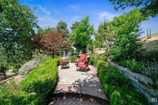 a view of a backyard with couches and a table and chairs