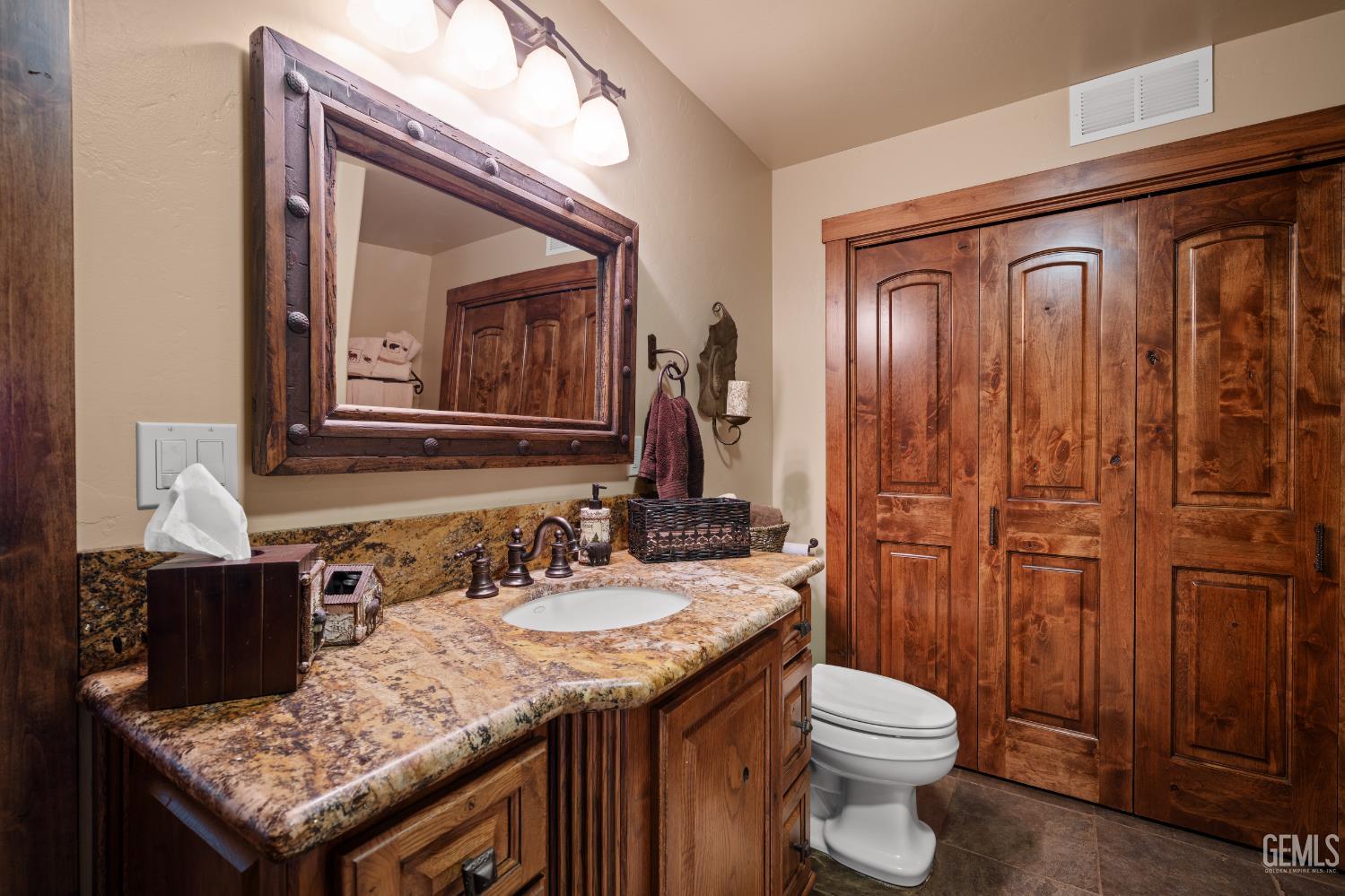 Undisclosed Address Tehachapi, CA 93561 - Photo 55 of 73 a bathroom with a granite countertop sink and a toilet