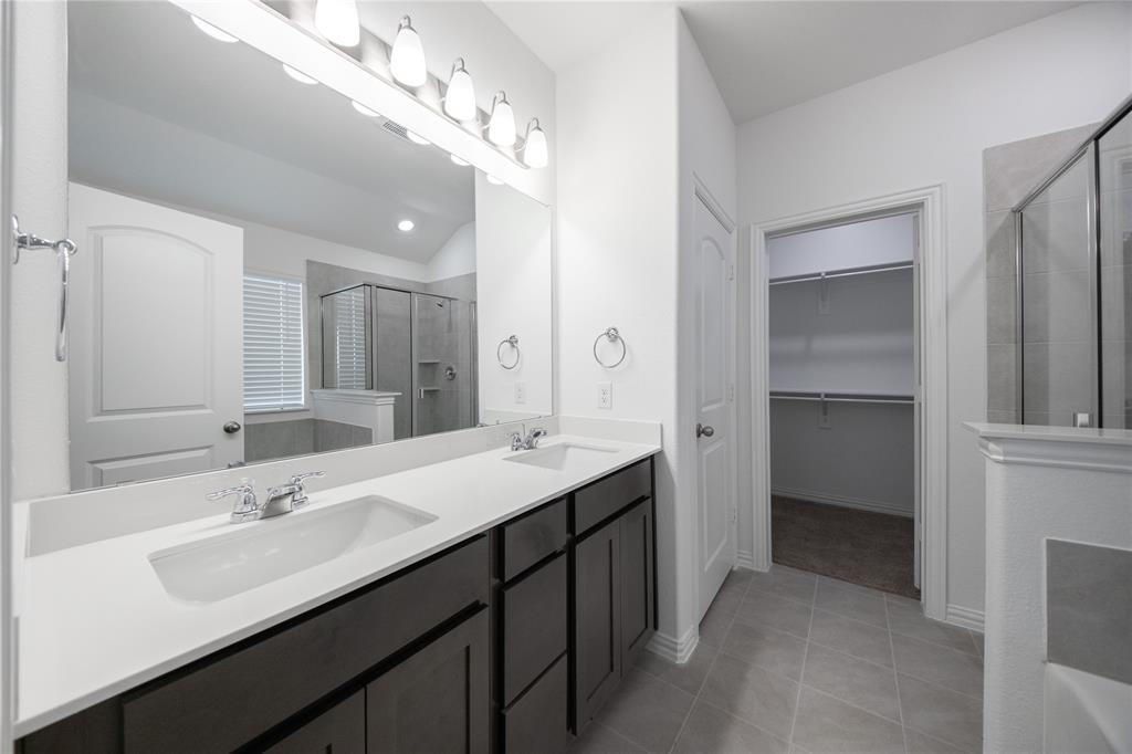 2015 Partridge Road Princeton, TX 75407 - Photo 12 of 27 a bathroom with a double vanity sink a vanity and a mirror