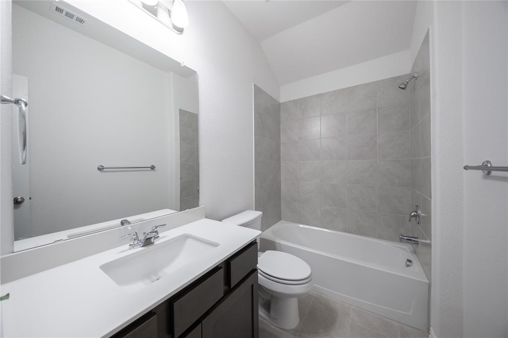 2015 Partridge Road Princeton, TX 75407 - Photo 16 of 27 a bathroom with a sink a toilet and shower