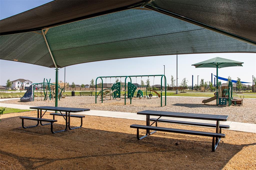 2015 Partridge Road Princeton, TX 75407 - Photo 25 of 27 a view of a patio with a table and chairs under an umbrella