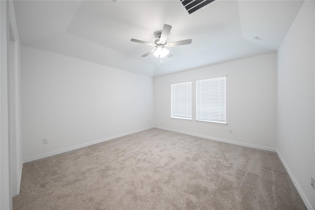 2015 Partridge Road Princeton, TX 75407 - Photo 10 of 27 an empty room with windows and fan