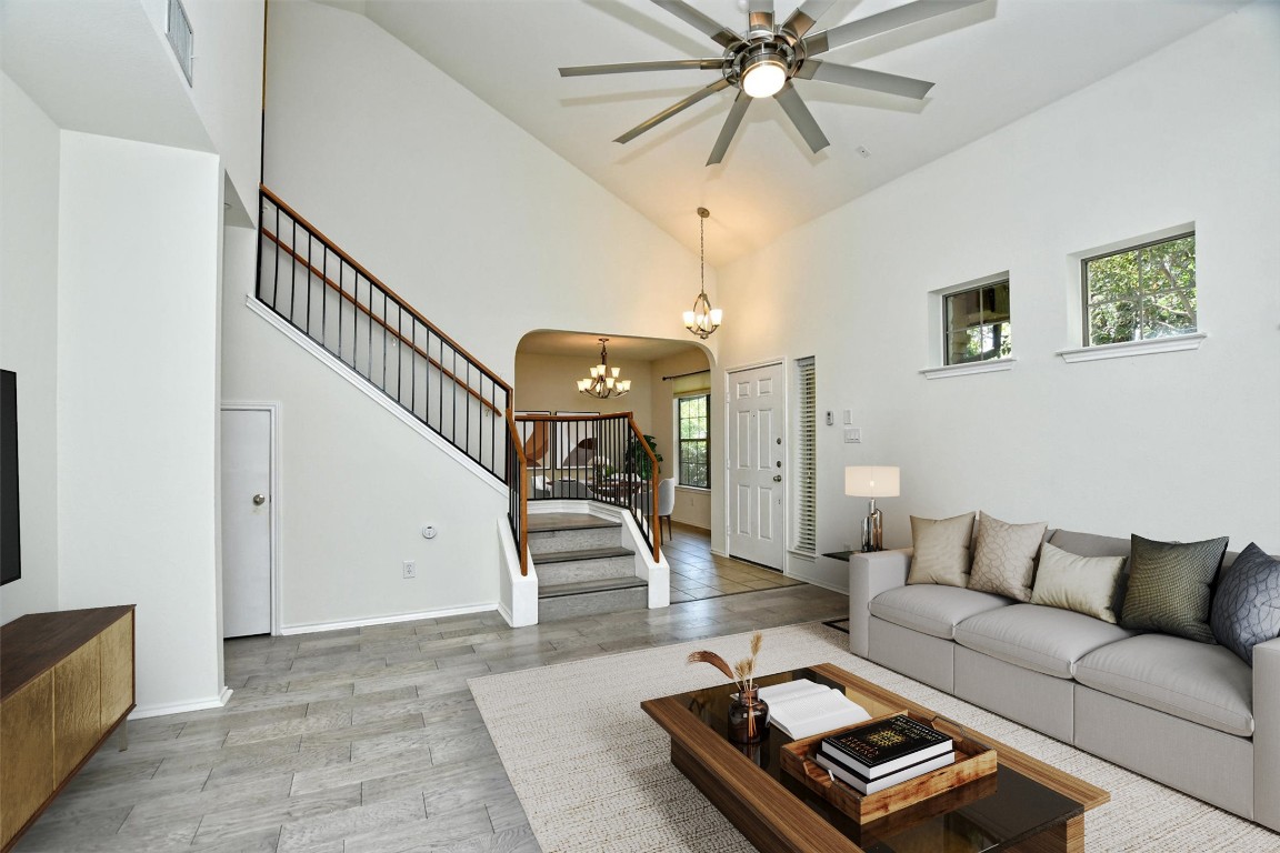 1310 West Parmer Lane, Unit 2803 Austin, TX 78727 - Photo 12 of 40 a living room with furniture and a chandelier