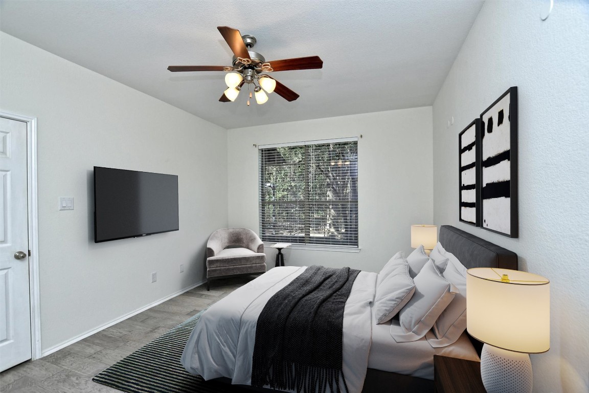 1310 West Parmer Lane, Unit 2803 Austin, TX 78727 - Photo 21 of 40 a bedroom with a bed and a flat screen tv