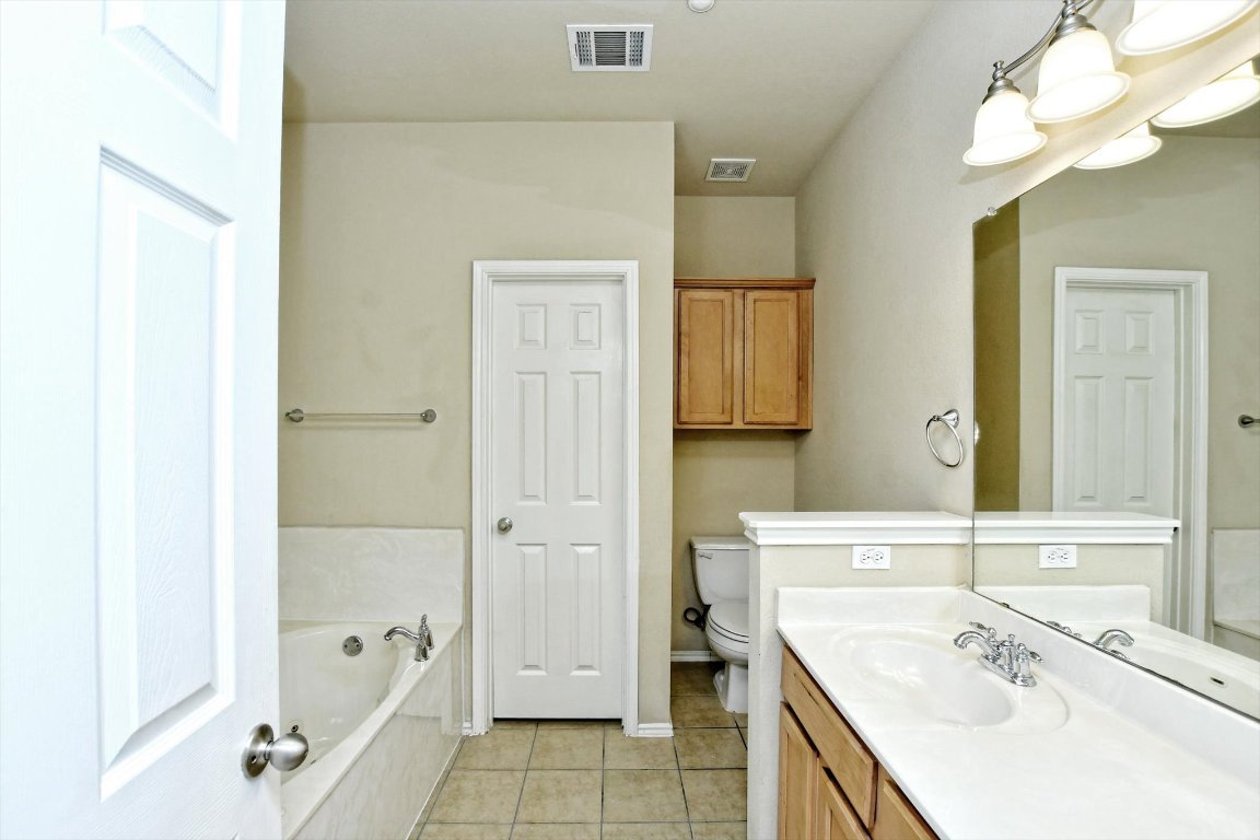 1310 West Parmer Lane, Unit 2803 Austin, TX 78727 - Photo 24 of 40 a bathroom with a tub sink and mirror