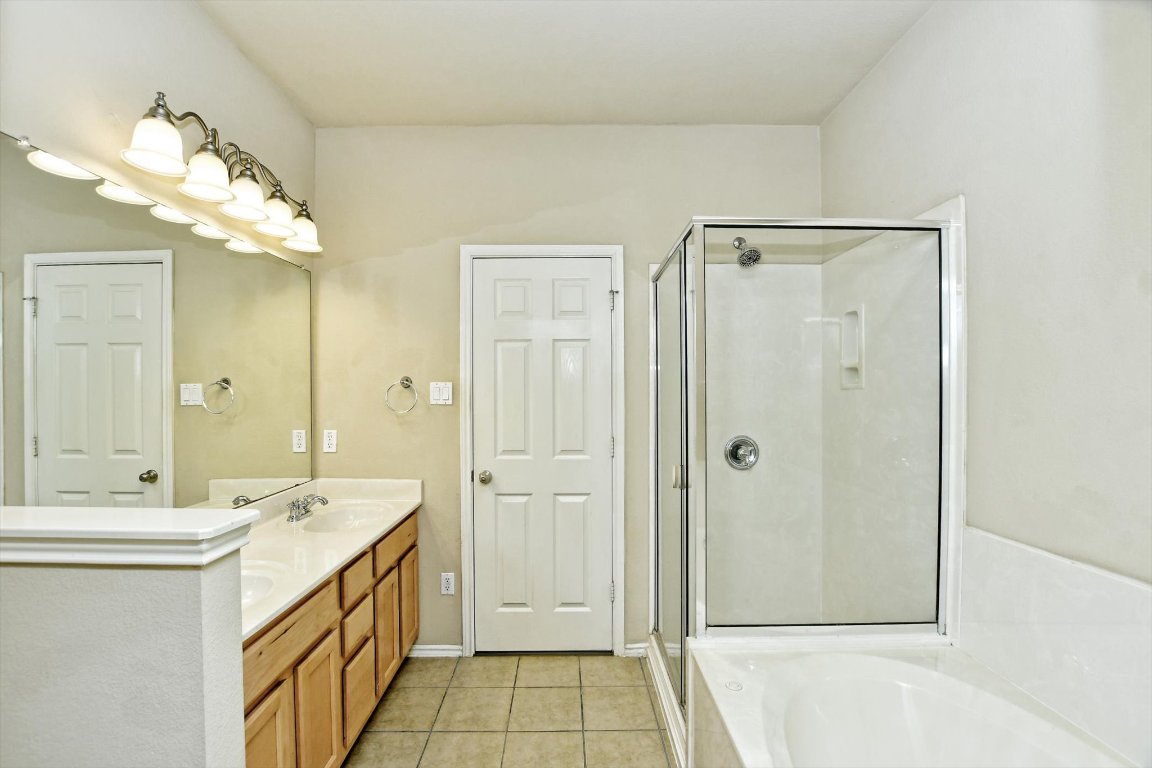 1310 West Parmer Lane, Unit 2803 Austin, TX 78727 - Photo 25 of 40 a bathroom with a double vanity sink mirror and shower