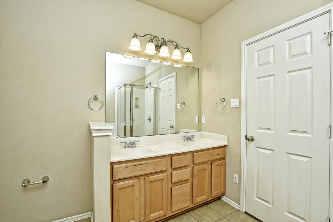 1310 West Parmer Lane, Unit 2803 Austin, TX 78727 - Photo 26 of 40 a spacious bathroom with a double vanity sink and a mirror