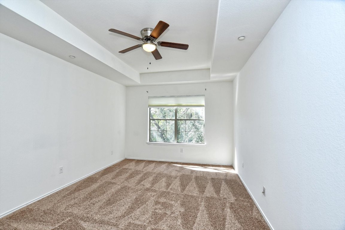 1310 West Parmer Lane, Unit 2803 Austin, TX 78727 - Photo 29 of 40 an empty room with a window and a fan