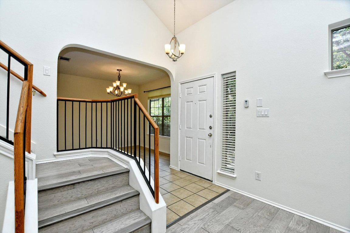 1310 West Parmer Lane, Unit 2803 Austin, TX 78727 - Photo 6 of 40 a view of a hallway with wooden floor and staircase