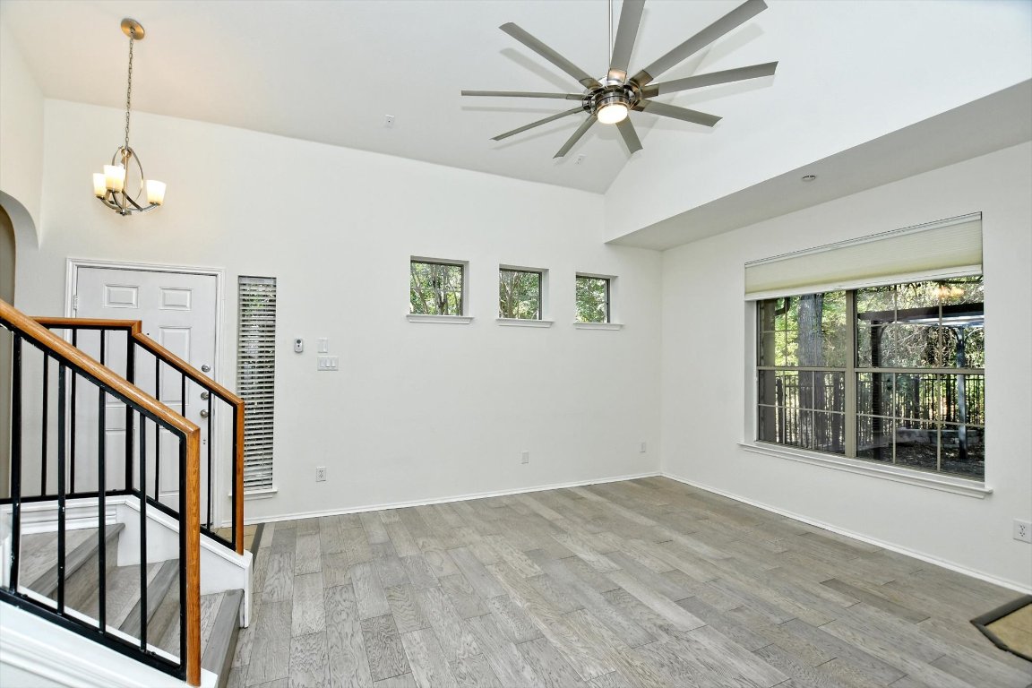 1310 West Parmer Lane, Unit 2803 Austin, TX 78727 - Photo 8 of 40 a view of an empty room with a window and wooden floor