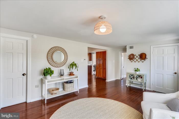 9333 Watkins Road Gaithersburg, MD 20882 - Photo 11 of 65 a living room with furniture and a dining table with wooden floor