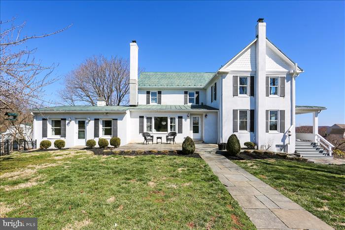 9333 Watkins Road Gaithersburg, MD 20882 - Photo 2 of 65 a front view of a house with a yard
