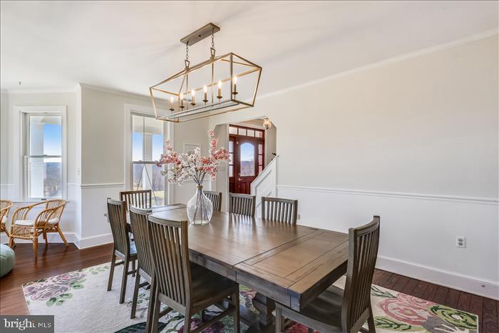 9333 Watkins Road Gaithersburg, MD 20882 - Photo 29 of 65 a view of a dining room with furniture and wooden floor