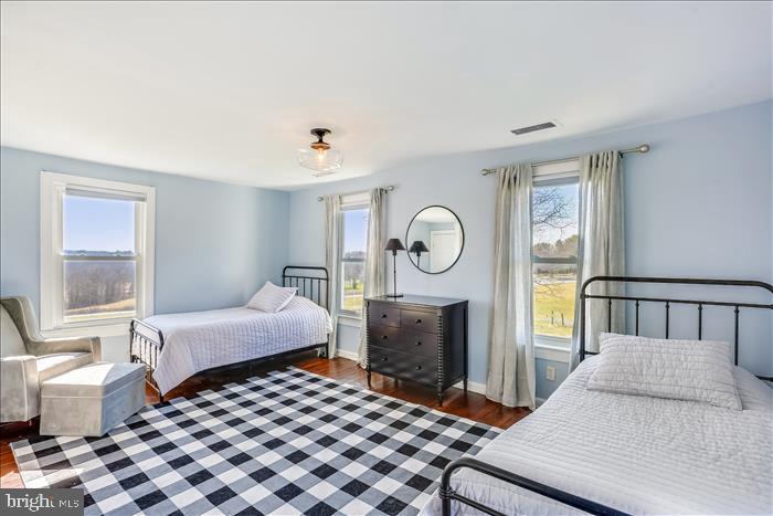 9333 Watkins Road Gaithersburg, MD 20882 - Photo 34 of 65 a bedroom with a bed and wooden floor