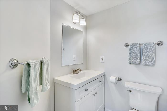 9333 Watkins Road Gaithersburg, MD 20882 - Photo 39 of 65 a bathroom with a sink and mirror with toilet