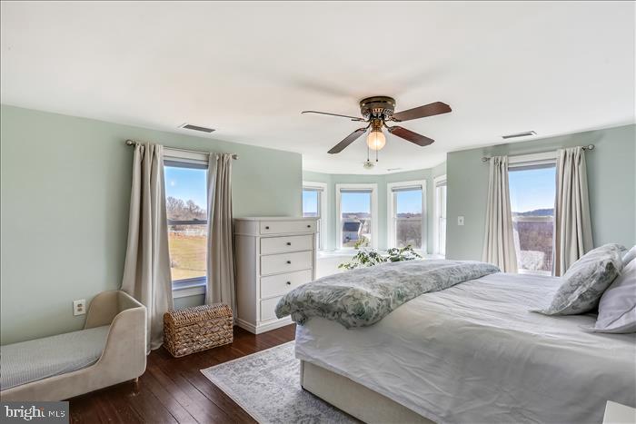 9333 Watkins Road Gaithersburg, MD 20882 - Photo 42 of 65 a bedroom with a bed and wooden floor