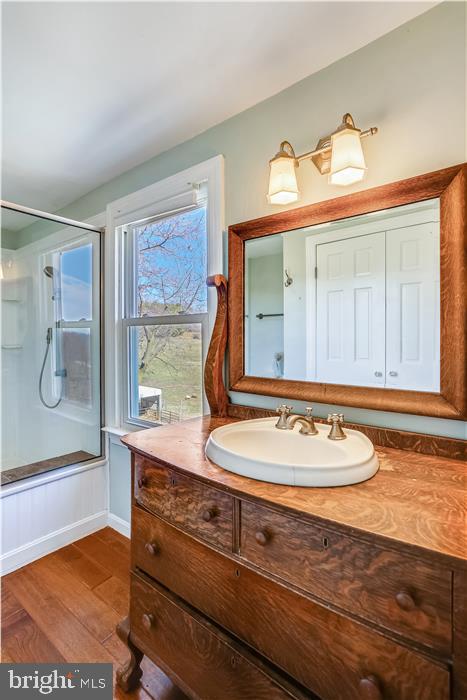 9333 Watkins Road Gaithersburg, MD 20882 - Photo 48 of 65 a bathroom with a sink a mirror and a shower