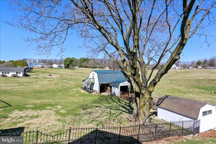 9333 Watkins Road Gaithersburg, MD 20882 - Photo 55 of 65 a view of a house with a yard
