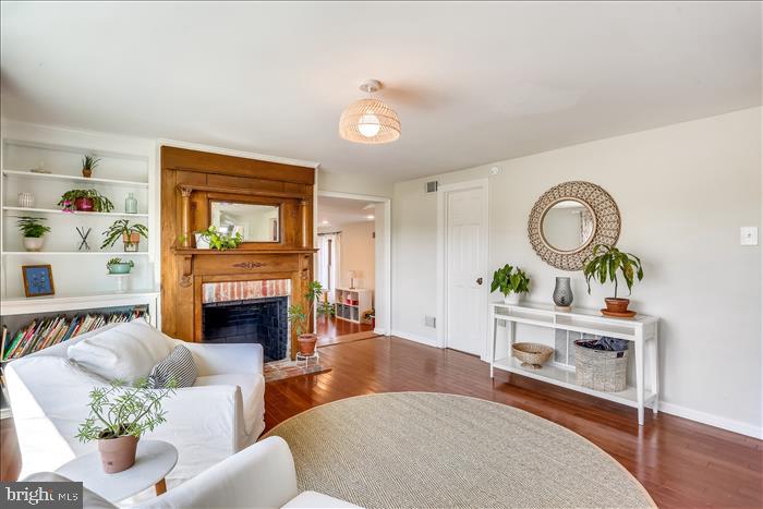 9333 Watkins Road Gaithersburg, MD 20882 - Photo 10 of 65 a living room with furniture a fireplace and a large mirror