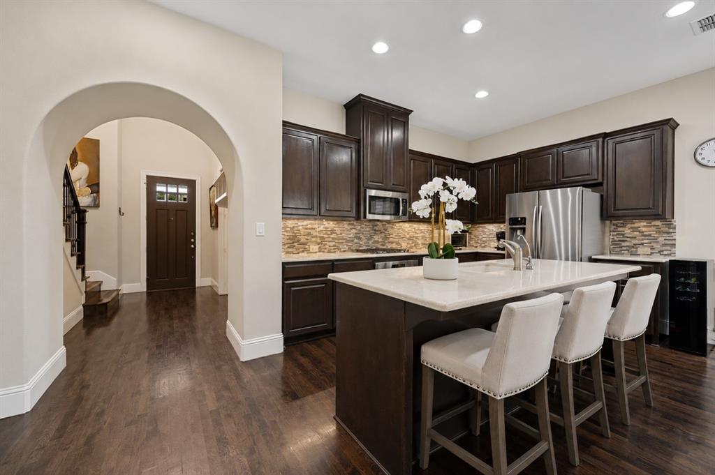 773 South Coppell Road Coppell, TX 75019 - Photo 8 of 30 a kitchen with a sink cabinets and wooden floor