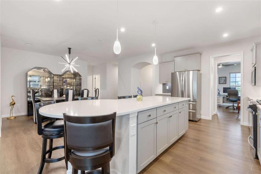 5213 Morrell Road Hoschton, GA 30548 - Photo 14 of 49 a large kitchen with a table and chairs