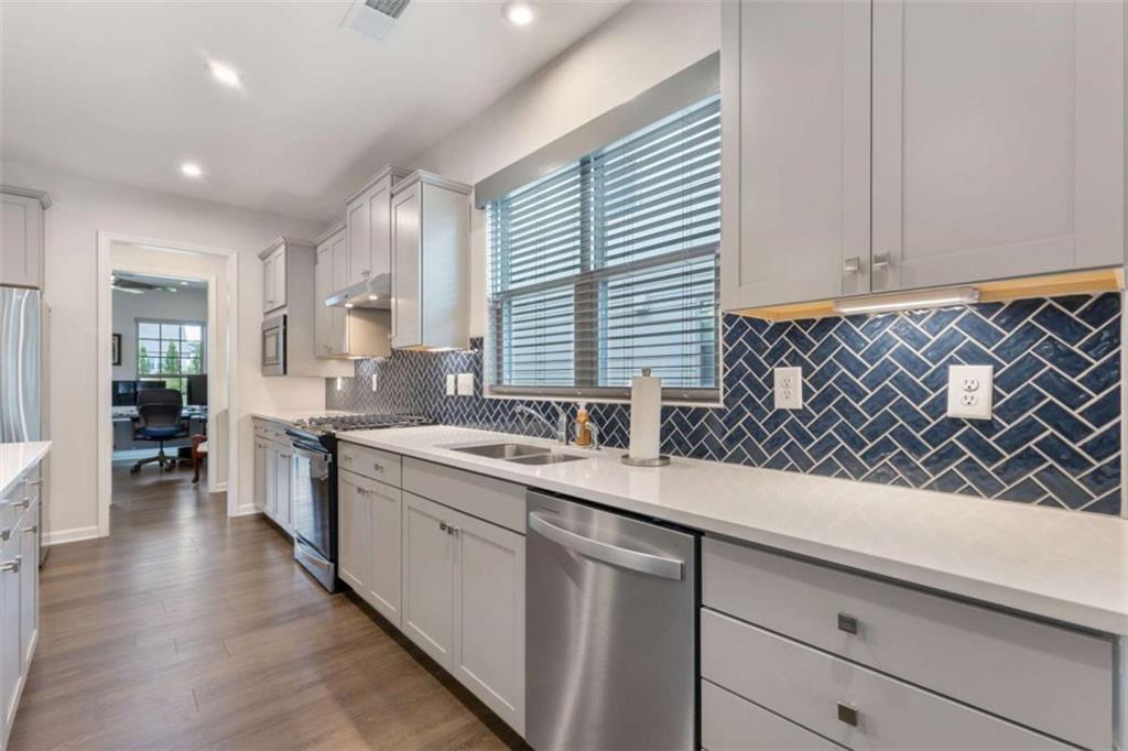 5213 Morrell Road Hoschton, GA 30548 - Photo 15 of 49 a kitchen with a sink and cabinets