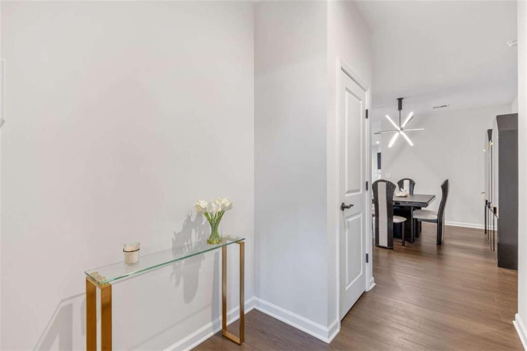 5213 Morrell Road Hoschton, GA 30548 - Photo 20 of 49 a view of a dining room with furniture and wooden floor