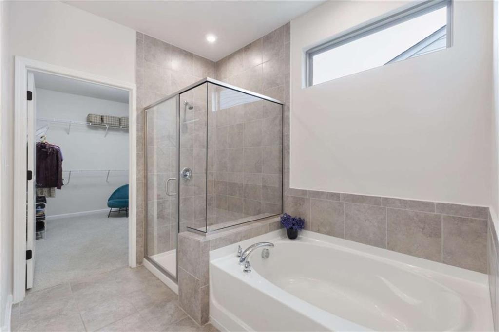 5213 Morrell Road Hoschton, GA 30548 - Photo 28 of 49 a bathroom with a bathtub and a shower