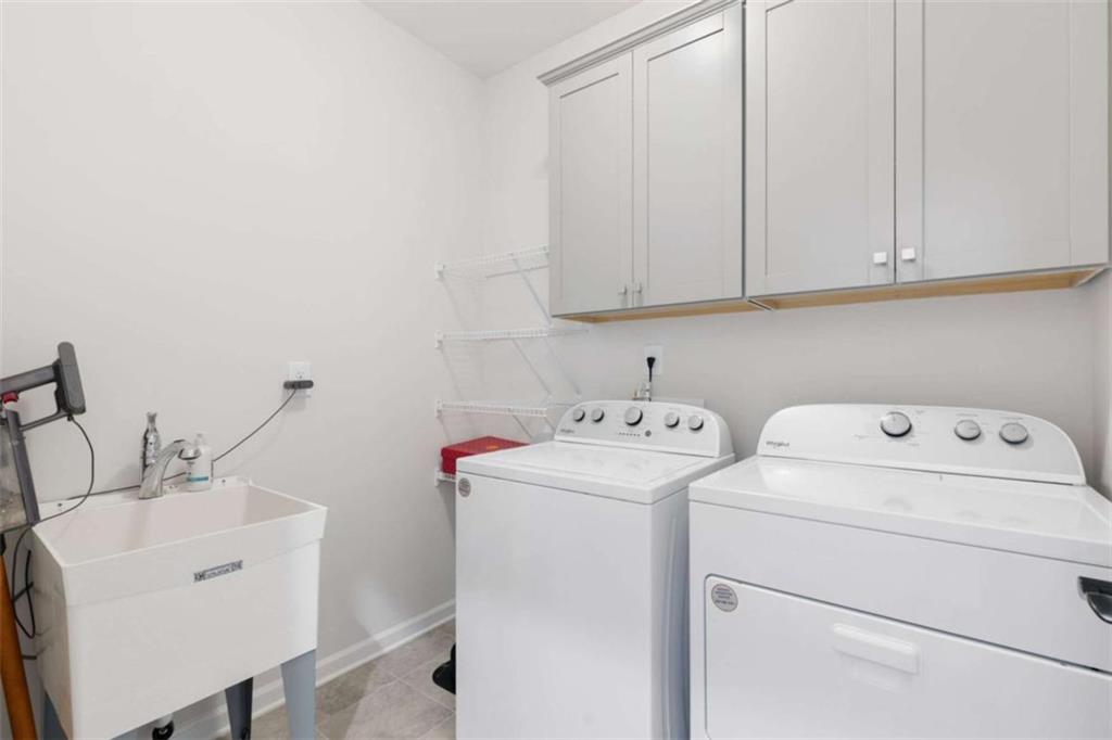5213 Morrell Road Hoschton, GA 30548 - Photo 30 of 49 a view of storage and utility room with washer and dryer