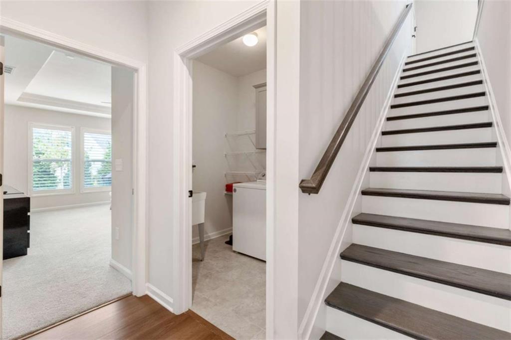 5213 Morrell Road Hoschton, GA 30548 - Photo 31 of 49 a view of entryway with wooden floor and stairs