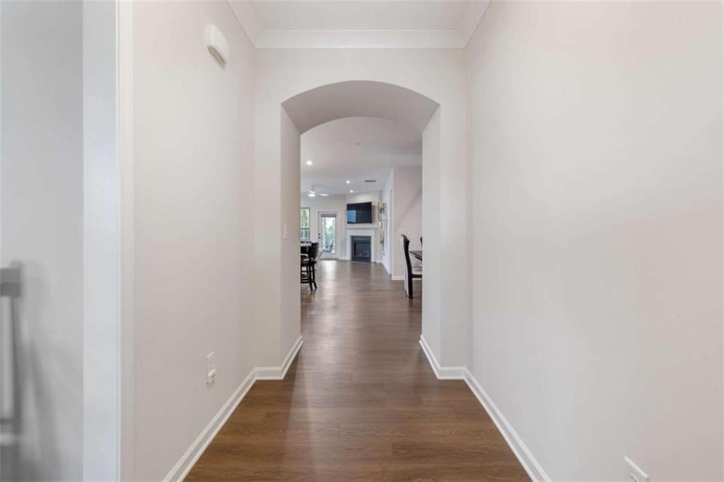 5213 Morrell Road Hoschton, GA 30548 - Photo 9 of 49 a hallway with wooden floor a table and chairs