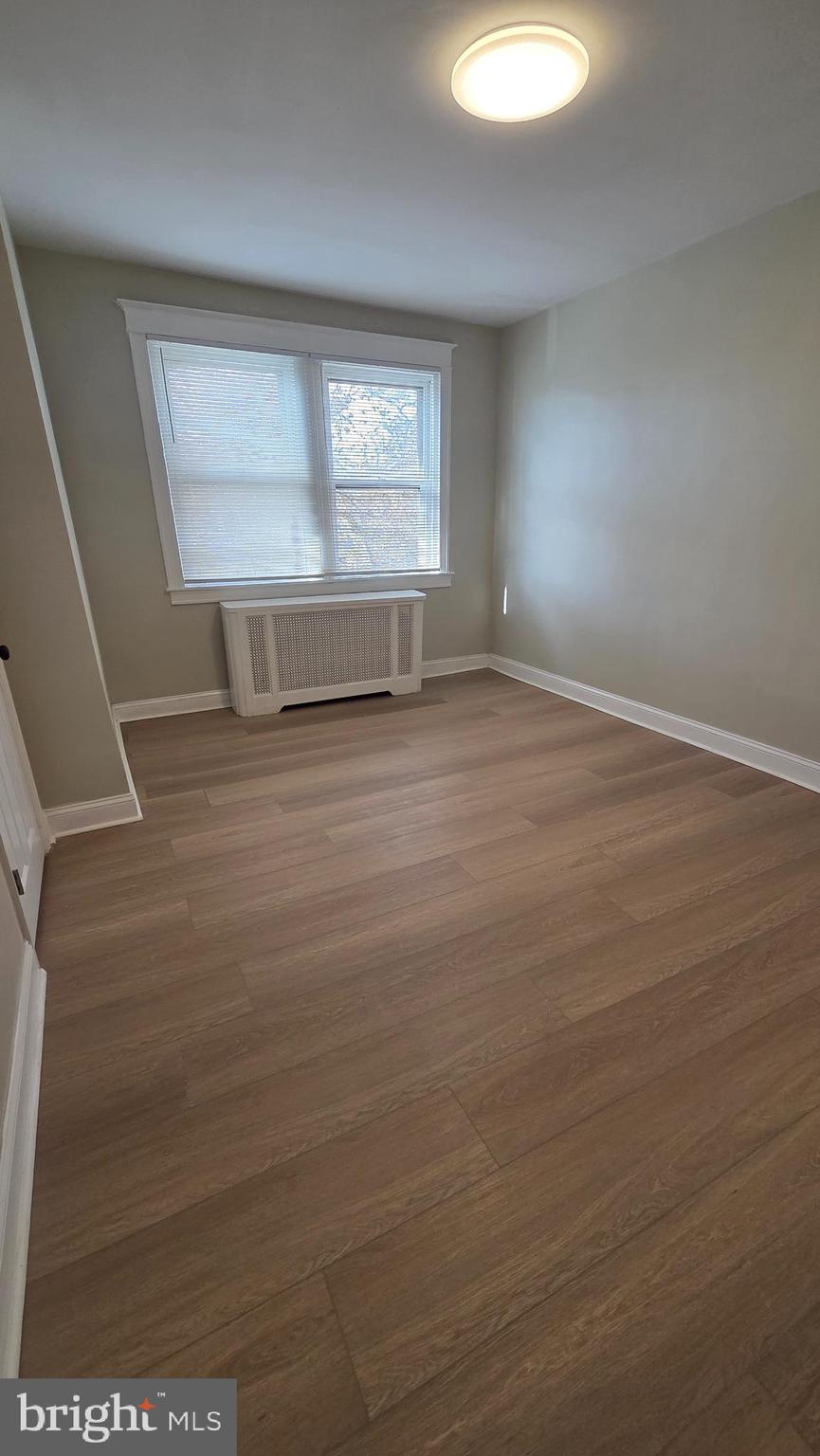 6519 Cutler Street Philadelphia, PA 19126 - Photo 14 of 24 an empty room with wooden floor and windows