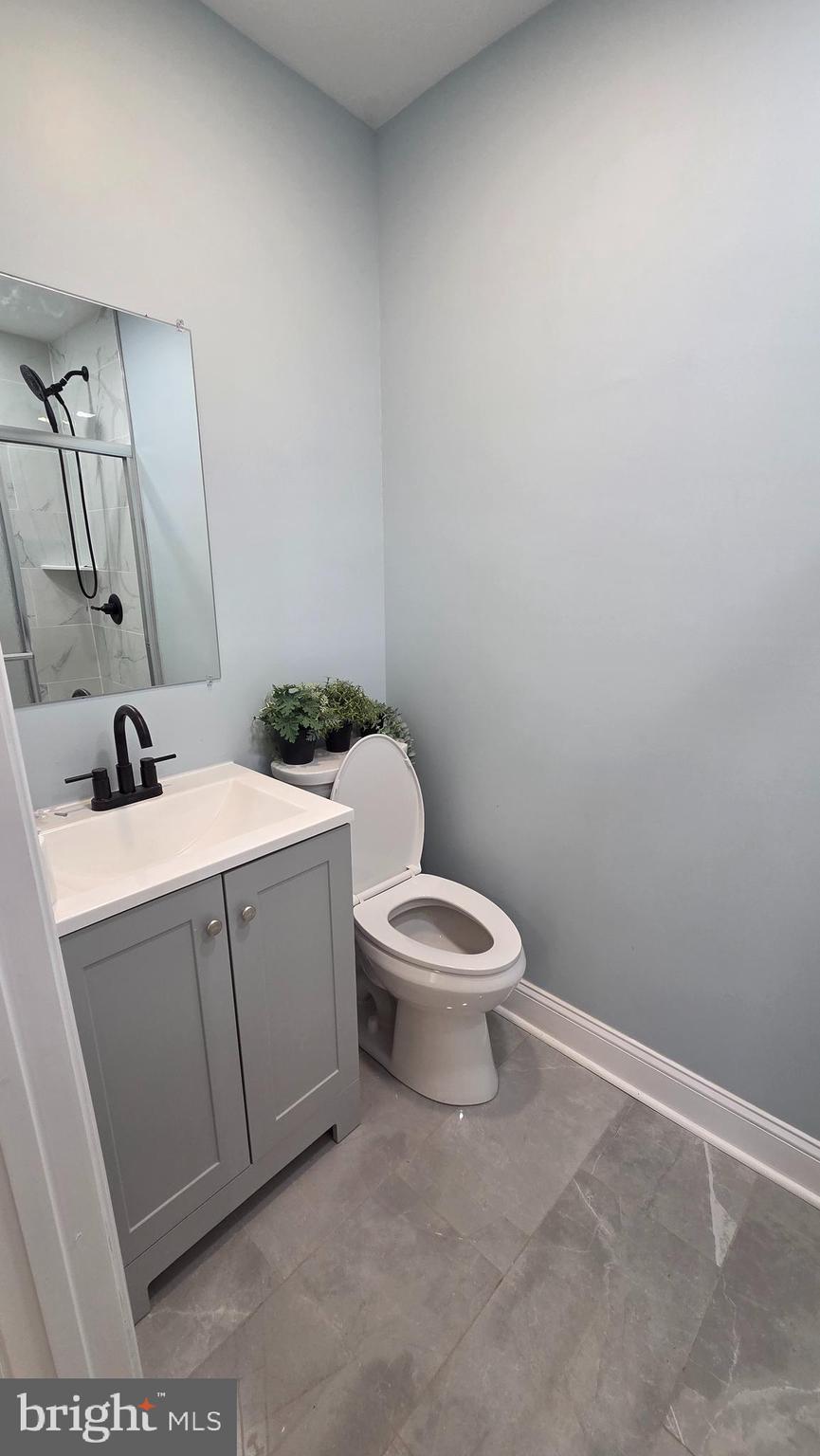6519 Cutler Street Philadelphia, PA 19126 - Photo 15 of 24 a bathroom with a toilet sink and mirror