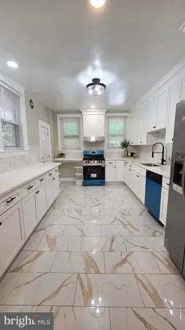 a kitchen with cabinets and chairs