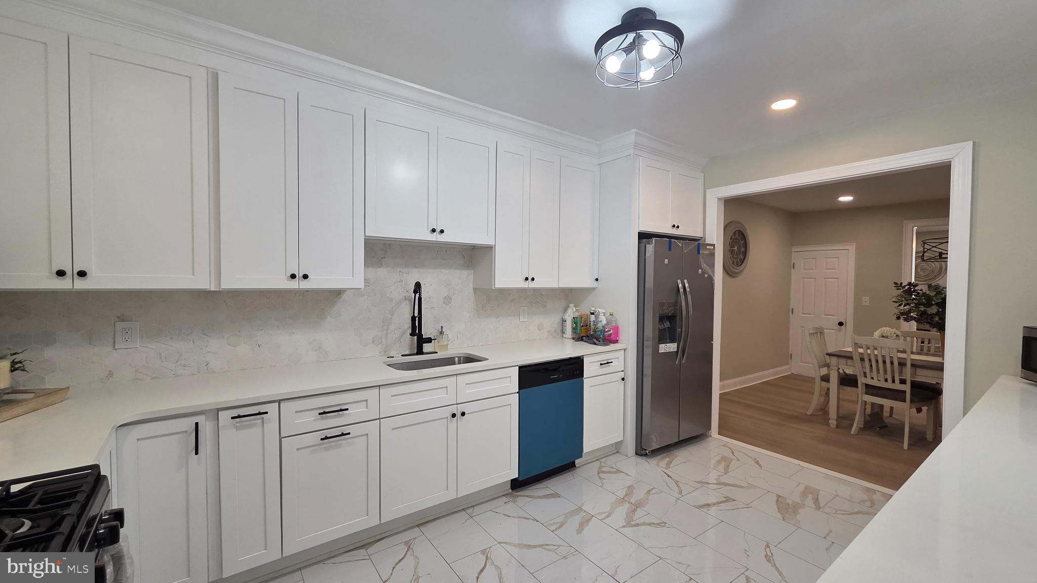 6519 Cutler Street Philadelphia, PA 19126 - Photo 7 of 24 a kitchen with cabinets and chairs
