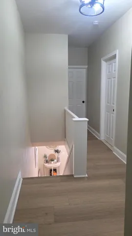a bathroom with a granite countertop bathtub shower sink vanity and toilet