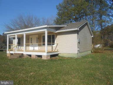 7384 Station Road Newcomb, MD 21653 - Photo 2 of 10 a front view of a house with a garden