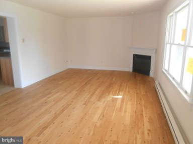 7384 Station Road Newcomb, MD 21653 - Photo 4 of 10 a view of empty room with wooden floor and fan