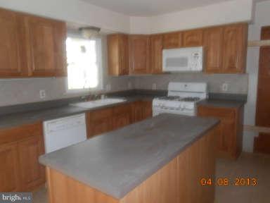 7384 Station Road Newcomb, MD 21653 - Photo 6 of 10 a kitchen with a sink a window and cabinets