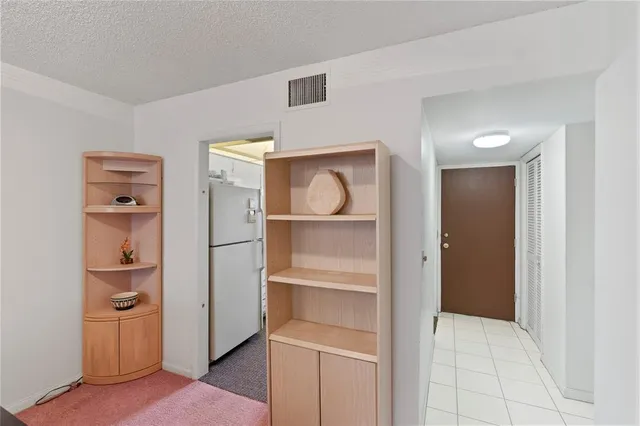 a bedroom with a bed wooden floor and window